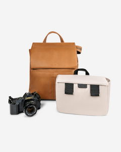 stylish camera bag backpack tan front view with camera and camera caddy