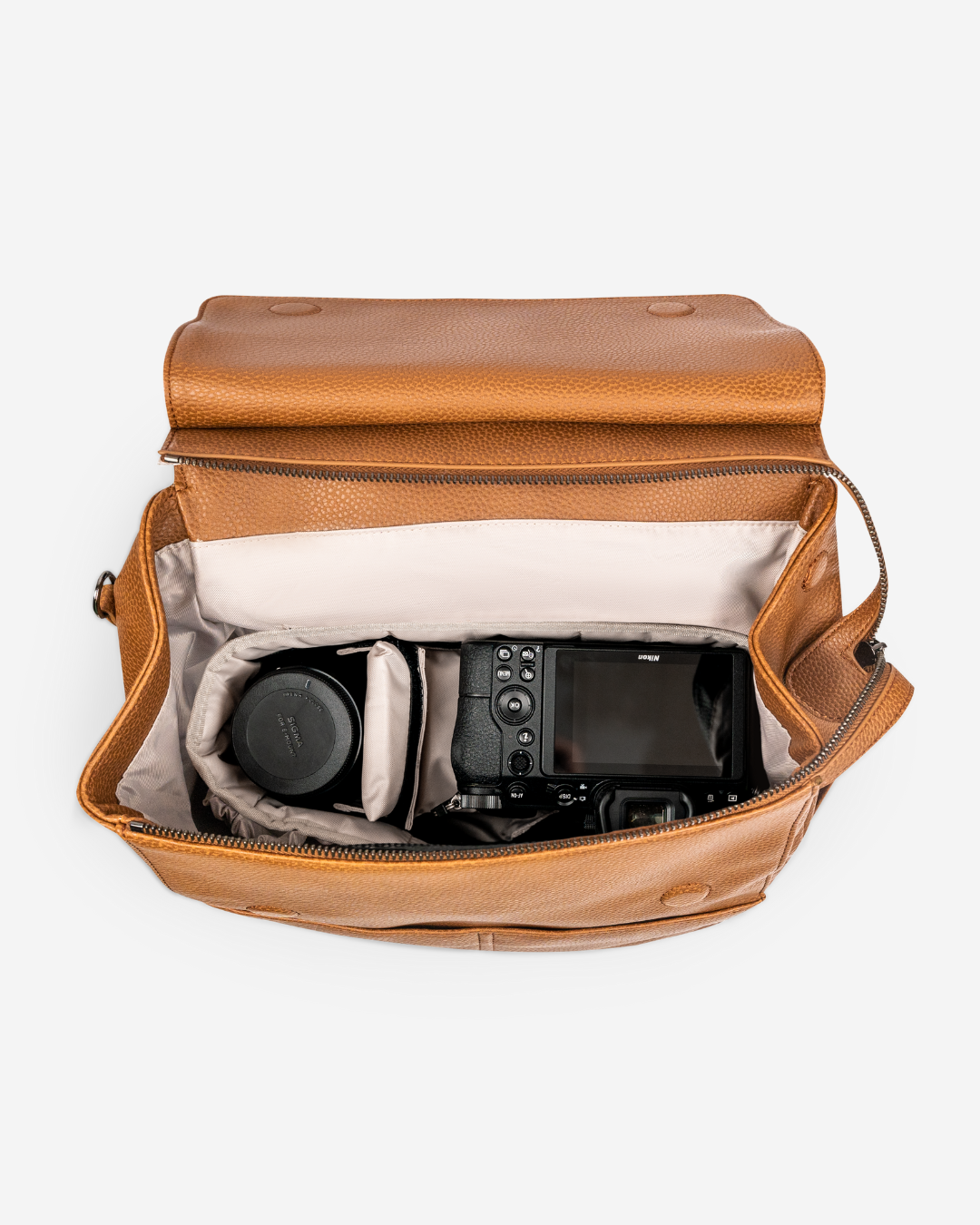 stylish camera bag backpack tan birds eye view with camera and lens inside padded lining