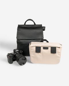 black stylish camera bag backpack black front view with camera and camera caddy
