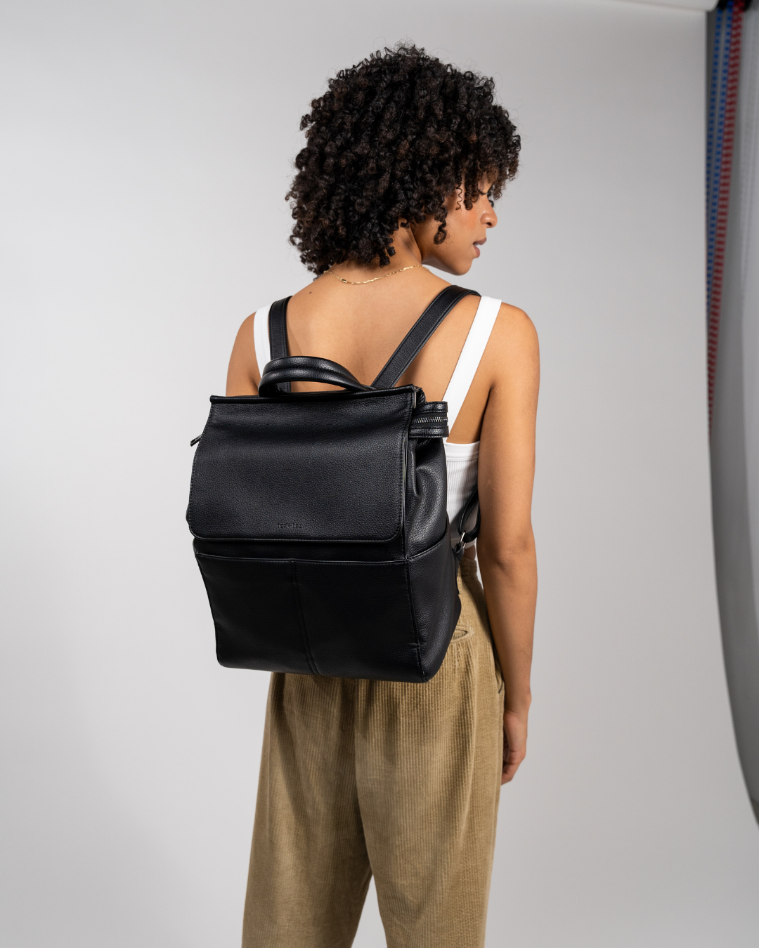 photographer wears black stylish camera bag backpack black back view